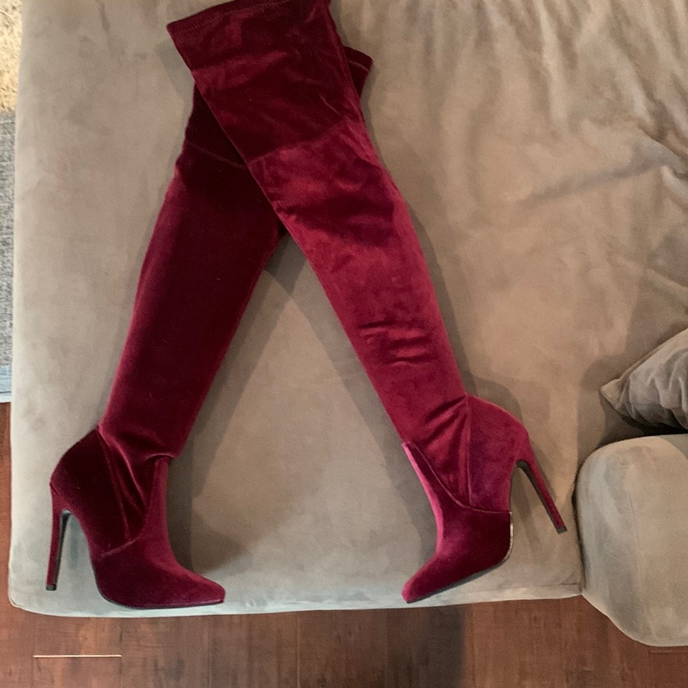 Over the knee burgundy High heel boots.